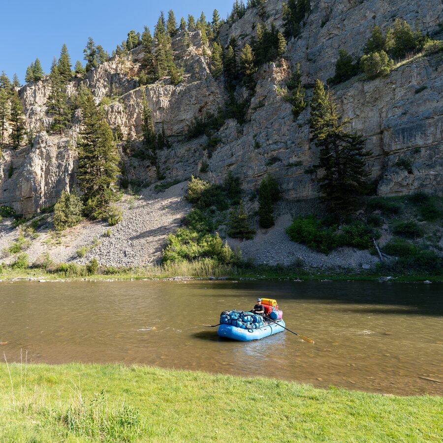 A loaded gear raft on the Smith, below the canyon wall