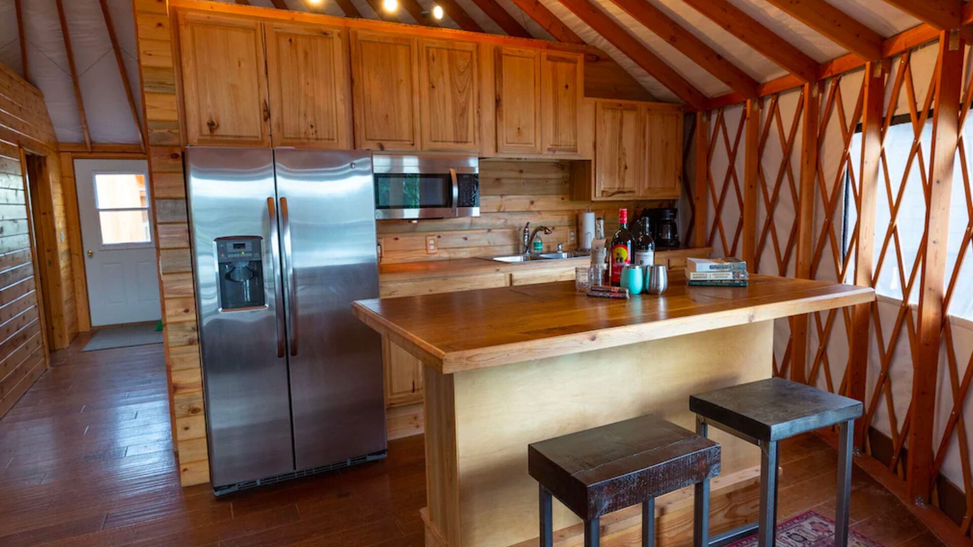 The yurt's kitchen, with a breakfast bar under the lattice walls