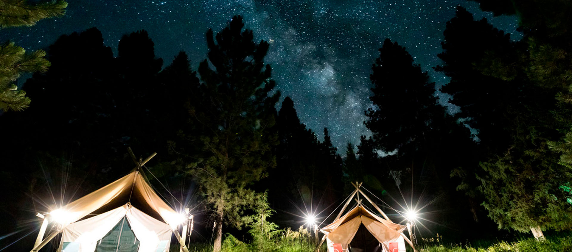 Tent Cabins under the night sky at the North Fork Crossing Lodge in Montana